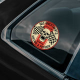 Sticker with a skull design and text on a car window