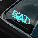 Blue 'BAD' decal on a car window