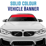 White BMW car with a solid red colour vehicle banner on the windshield.