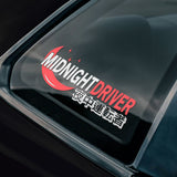 Car window with 'Midnight Driver' decal