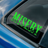Green 'Misery Loves Mercy' decal on a car window