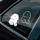 Two cartoon-like penis/dick decals on a car window 