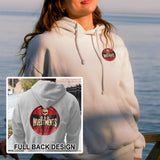 A woman wearing a white hoodie with a 'BAD INVESTMENTS' label on the back. The hoodie features a skull and crossbones design on the front.