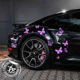 Black car with pink butterfly decals on a dark background