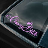 A purple decal with the phrase 'Classy Bitch' in cursive script, applied on the rear window of a black vehicle.
