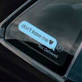 Car window with a digital message sticker reading 'don't leave me' and 'Not Delivered'.