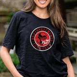 A person wearing a black t-shirt with a red and white 'BAD INVESTMENTS AUTO CLUB' logo and a smoking skull graphic.