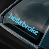Car window with 'hella broke' decal