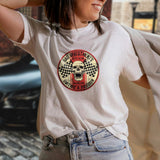 Girl wearing a white tshirt with a red and beige skull design.