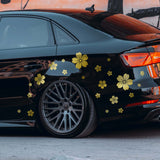Black car with gold floral decals on a street background
