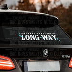 White and Teal vinyl decal mockup saying "Always Take The Long Way" with floating flower petals around the letters shown on a BMW car rear window