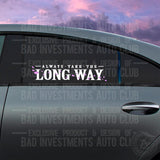 White and Pink vinyl decal mockup saying "Always Take The Long Way" with floating flower petals around the letters shown on a car window