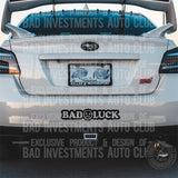 Bad Luck with a sad face sticker on car rear bumper by Bad Investments Auto