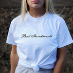 Female model wearing a white tshirt of our branded script logo Bad Investments Auto Club design