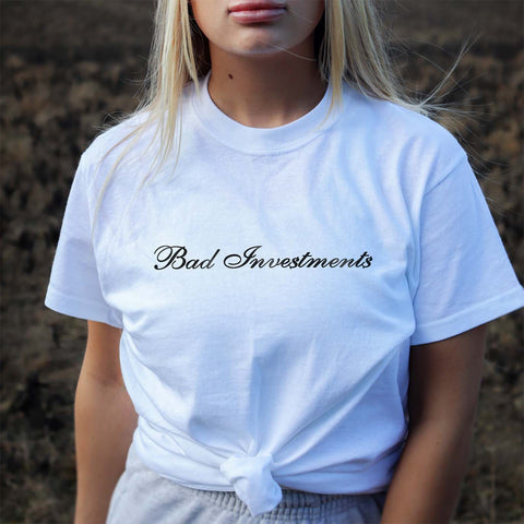 Female model wearing a white tshirt of our branded script logo Bad Investments Auto Club design